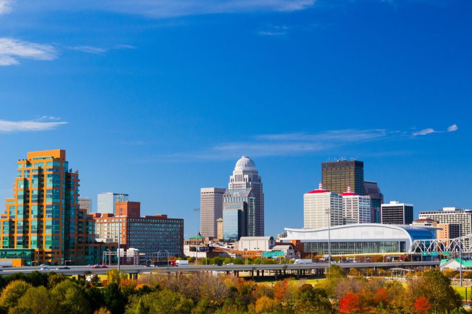 Louisville, Kentucky skyline with distinctive buildings under a clear blue sky.
