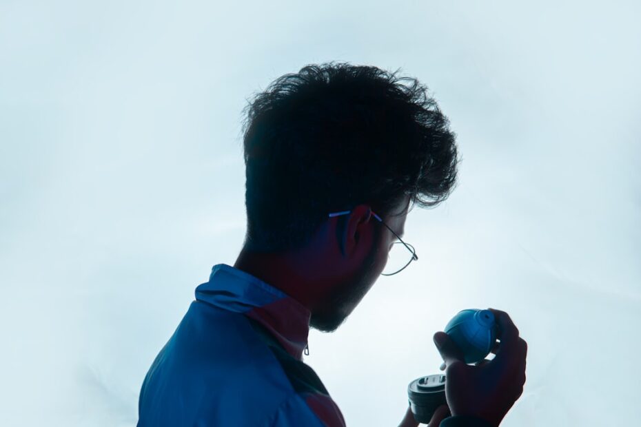 Close-up shot of a person speaking into their smartphone, which has a glowing, futuristic interface, representing the futu...