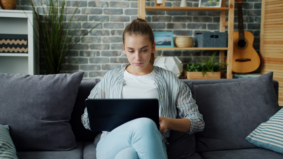 A property owner strategically managing their short-term rental on a tablet in a stylish, modern home environment.