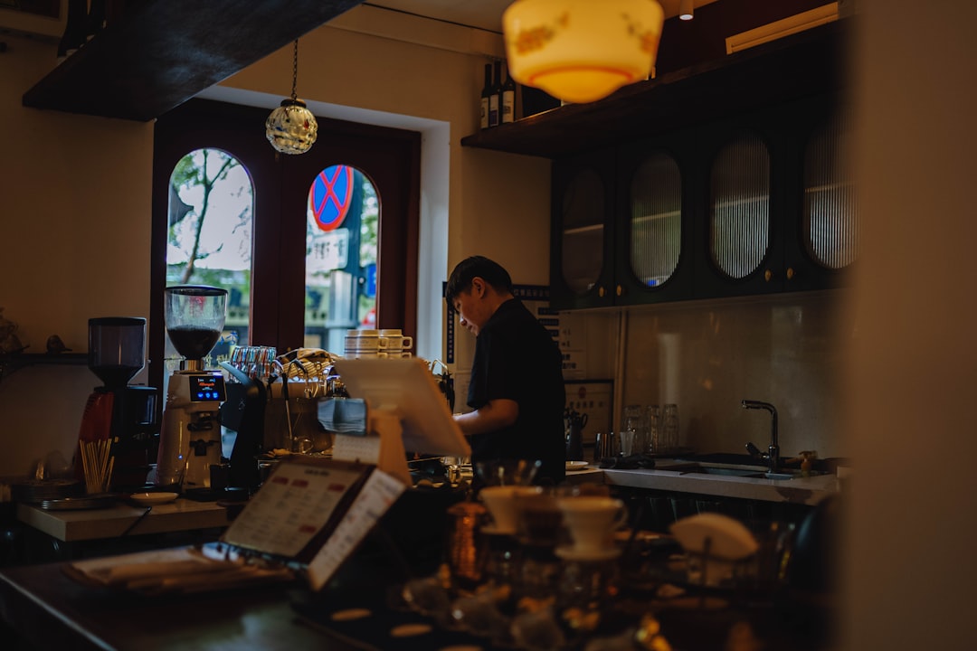 The warm and inviting interior of a bright, modern local coffee shop, a perfect example of a community 'third place' that boosts neighborhood appeal.