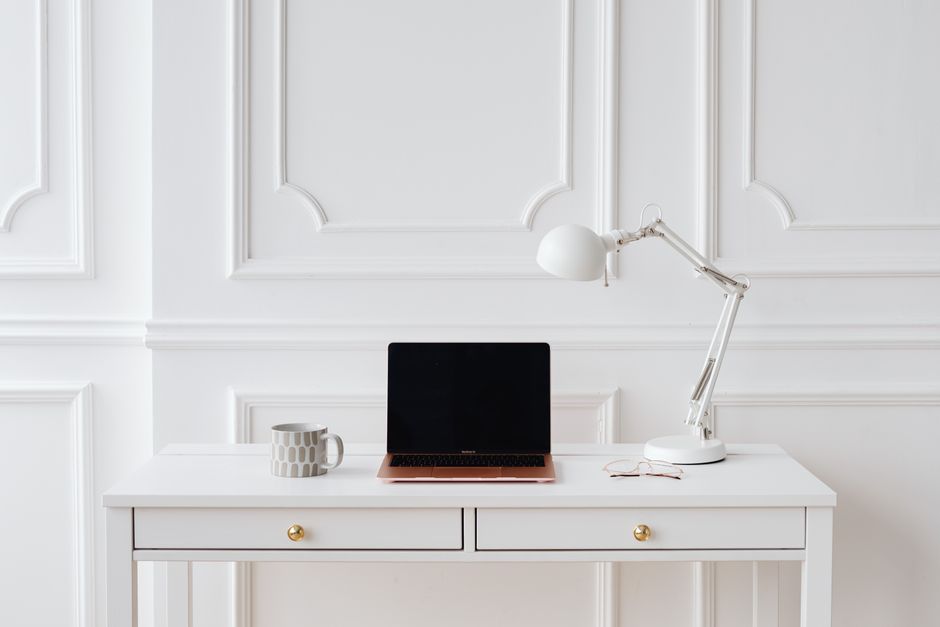 A sleek, modern compass sits on a bright, organized desk, symbolizing the strategic direction needed to build a real estate brand beyond generic platforms.